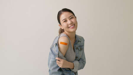 Young attractive beautiful asia female or teenage receive covid-19 anti virus vaccine in campaign...