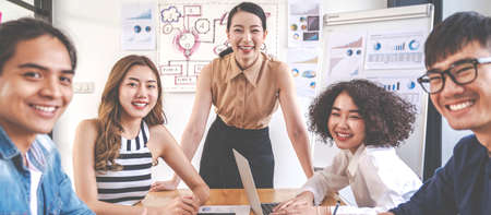 Banner of Happy creative team are smiling and looking at camera in modern workspace office. Happy...