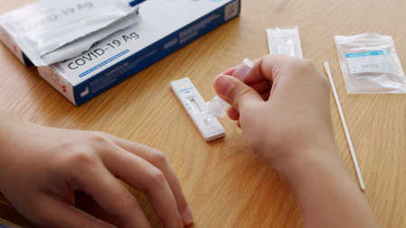 Close-up face of young adult asia woman people use auto PCR cotton self cure kit from hospital...