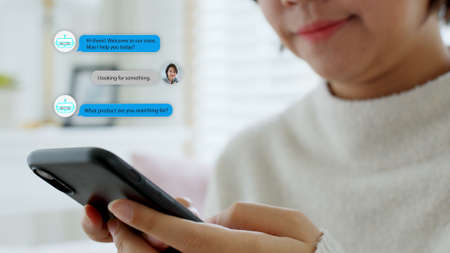 Close-up hand asian people use mobile phone happy buy online at home talk to ai shop store app ask data chat bot in sme social e-commerce web B2C crm iot pop up dialog text help seller smart life.の写真素材