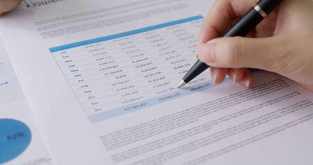 Stock trader agent or MBA student learn tax wealth working at lawyer office use pen in hand checking...