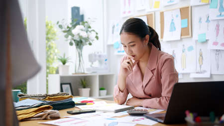 Woman seller SME retail store owner work hard worry stress in bad news on laptop at home office...
