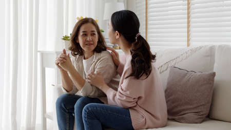 Unhappy Female employee latin mom think sit sofa couch at home living room need help support panic financial debt crisis in life insurance feel pain distress pensive regret lost upset.の写真素材