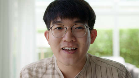 screen face of asia people man smile look camera remote work at home talk on VoIP web social media...