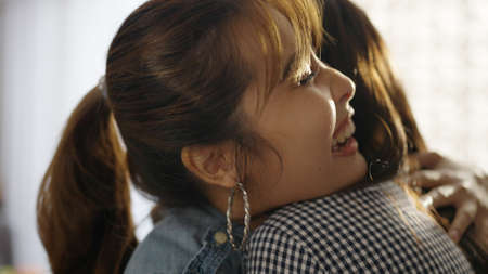 Asia female casual teen laugh smile walk enter to cafe pub bar or coffee shop store open after post pandemic. Girl friend invite to fun party enjoy good news trust warm time in youth people.の写真素材