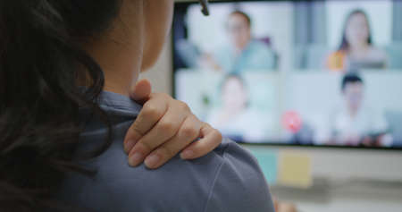 Young adult asia people busy work hard video call online group talk relief wrist pain carpal tunnel...