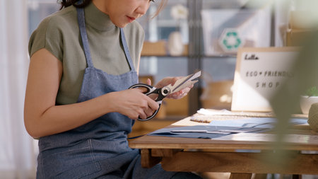 Eco vendor go green packaging parcel carton box in net zero waste store asian seller retail shop. Earth care day small SME owner asia people wrap reuse brown paper pack gift reduce plastic free order.の写真素材