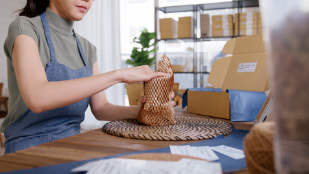 Eco vendor go green packaging parcel carton box in net zero waste store asian seller retail shop. Earth care day small SME owner asia people wrap reuse brown paper pack gift reduce plastic free order.の写真素材