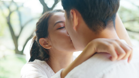 Young adult asia people fiance happy lover flirt fall in love nose lips kiss hug cuddle care trust. Sweet comfort touch newlywed asian couple life man smile look at woman face relax warm time dating.の写真素材
