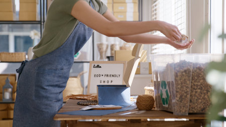 Eco vendor go green packaging parcel carton box in net zero waste store asian seller retail shop. Earth care day small SME owner asia people wrap reuse brown paper pack gift reduce plastic free order.の写真素材