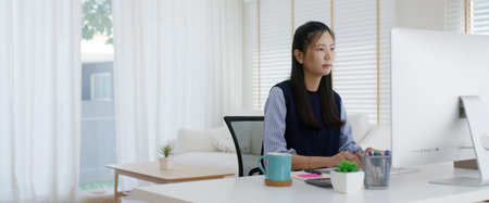 Young lady asia people teen girl talent workforce remote work at home office workspace sit relax on desk table. Distant job digital learn online reskill upskill career coding class chat on desktop PC.の写真素材