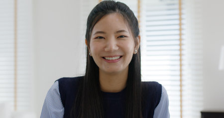 Asia people young casual woman sit smile work at table desk home workspace self learn on laptop in modern workforce reskill career upskill job data analyst MBA lesson. Happy face girl look at camera.の写真素材