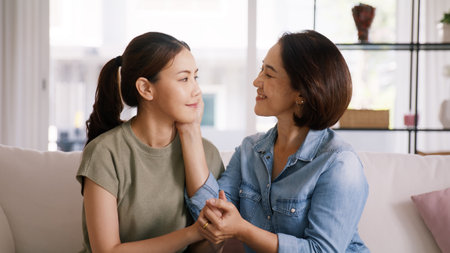 Middle aged asia people old mom love care trust comfort help young teen talk crying stress relief at home. Mum as friend listen adult child woman feel pain sad worry of broken heart life crisis issuesの写真素材