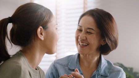 Middle aged asia people old mom love care trust comfort help young teen talk crying stress relief at home. Mum as friend listen adult child woman feel pain sad worry of broken heart life crisis issuesの写真素材