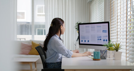Smart Gen Z tech talent workforce typing SEO sale report on desktop PC happy work easy relax at home...