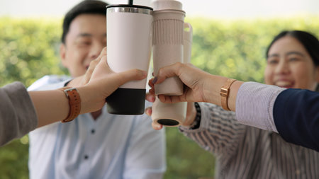 Gen Z asia people group save the planet earth relax cheers coffee drink go green eco friendly reduce plastic waste free issues water bottle tumbler glass cup SDGs office. ESG care net zero happy team.の写真素材