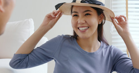 Relax safe get away ready to get back to road trip. Asia people man woman choose clothing with love smile happy plan enjoy dating sit laugh fun folding stuff stack face mask open and neat bag at home.の写真素材