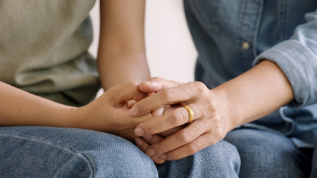 Middle aged asia people old mom holding hands trust comfort help young woman talk crying stress relief at home. Mum as friend love care hold hand adult child feel pain sad worry of life crisis issues.の写真素材