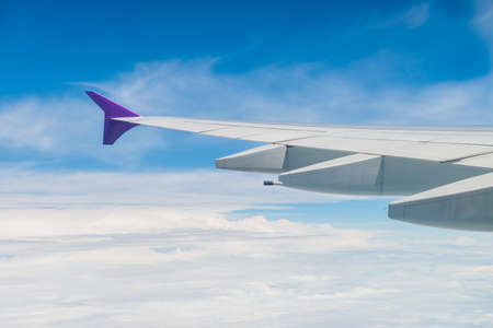 Clouds and sky as seen through window of an aircraft