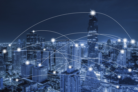 Network conection concept on blue tone aerial view of cityscape business district at twilight  background.の写真素材