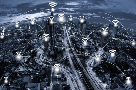 Wifi network connection concept and Network business conection system on blue tone Aerial view of cityscape Bangkok business district at twilight  background.の写真素材