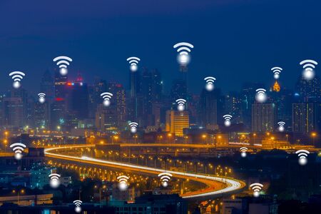 Wifi network connection concept on aerial view of cityscape business district at twilight background.の写真素材