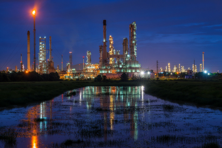 Oil refinery or petroleum refinery industry landscape with reflection at twilight time in the morning. Industrial estate of Thailand, industrial process plant where crude oil is processed and refined.の写真素材