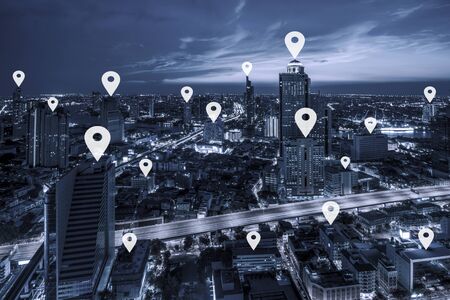 Map pin flat on blue tone Aerial view of cityscape Bangkok business district at twilight  background.の写真素材