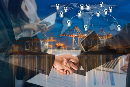 Double exposure of business people handshake greeting deal concept on Industrial port with containers cargo ship background and map pin flat network conection on world global cartography globalizationの写真素材