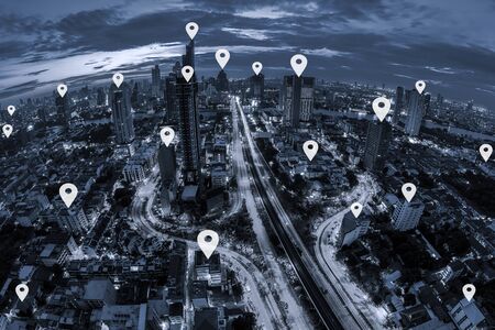 Map pin flat on blue tone Aerial view of cityscape Bangkok business district at twilight  background.の写真素材