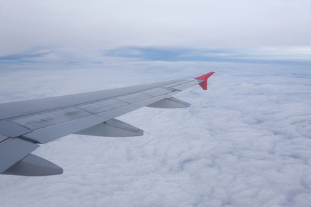 Wing of airplane flying above the clouds .の写真素材