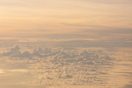 Flying above the clouds at twilight time.
