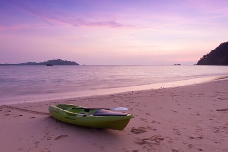 Canoe on the beach at twilight time.の写真素材