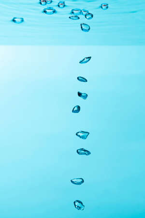 Air bubble and water splash,Water splash isolated on blue background.の写真素材