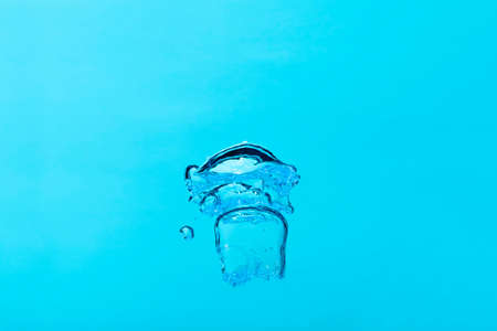 Big air bubble on blue water ,isolated on blue background.