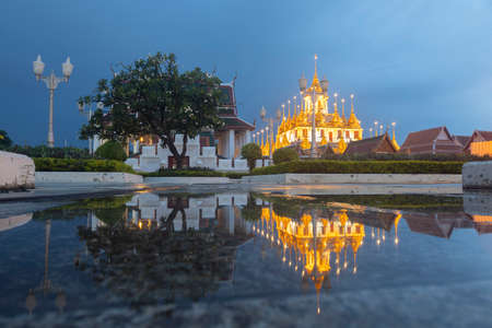 Reflection of Wat Ratchanatdaram Temple the beautiful golden castle or pagoda Bangkok, Thailand