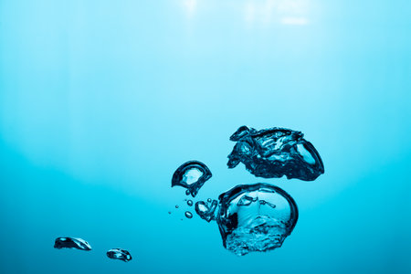 Big air bubble are rising in the blue water , air bubble isolated on blue background