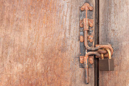 The Rusty lock with wood door, Old lock close home door.の写真素材