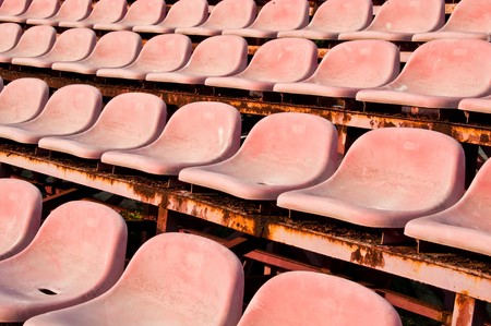 old red seats in a Stadiumの写真素材