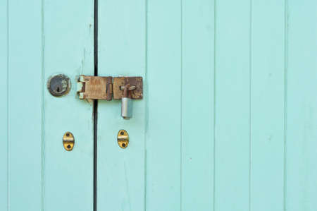 Door lock and green door as a backgroundの写真素材