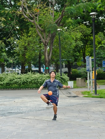 Bangkok, Thailand - April 24, 2011- A man playing Sepak takraw in a public park of Bangkok.のeditorial素材