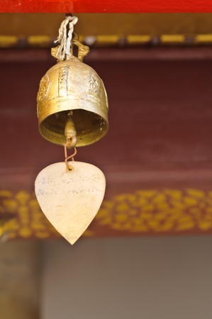 a small bell hanging under the temple roof  at the marble temple or Wat Benchamabophit, Bangkok.の写真素材