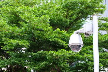Security surveillance camera in front of office building walk way. Record situation around area standard safety system in smart modern building. Help to prevent crime.の写真素材