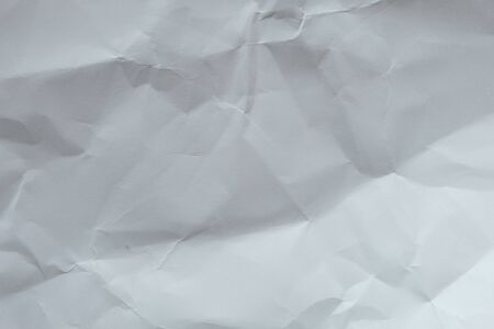 Wrinkled white blank plain paper with shade of light and shadow. Ideal for background or wall wallpaper with copy space for text.の写真素材