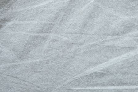 Wrinkled White fabric close up shot of good quality Cotton and polyester shirt. formal wear for office worker . Background texture concept with copy space for text.の写真素材