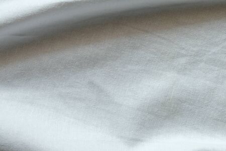 Wrinkled White fabric close up shot of good quality Cotton and polyester shirt. formal wear for office worker . Background texture concept with copy space for text.の写真素材