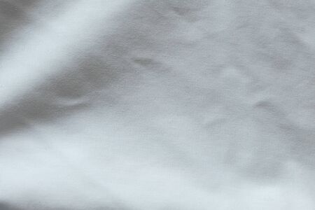 Wrinkled White fabric close up shot of good quality Cotton and polyester shirt. formal wear for office worker . Background texture concept with copy space for text.の写真素材