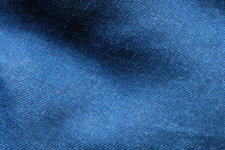 Selective focus blue jean denim top view close up shot to the detail of fabric. textile material and cotton patter tough and durable garment style. For background or wallpaper with copy space for textの写真素材