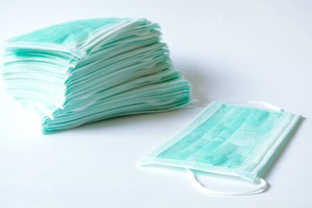 Green color Medical mask for protection against flu and other diseases. Surgical protective mask. Medical respiratory bandage face on isolate white background. prevention of the spread of virusの写真素材