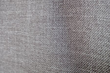 Selective focus, Close up shot of dark grey formal suit cloth textile surface. wool fabric texture for important luxury evening or night event. Wallpaper and background with copy space for textの写真素材
